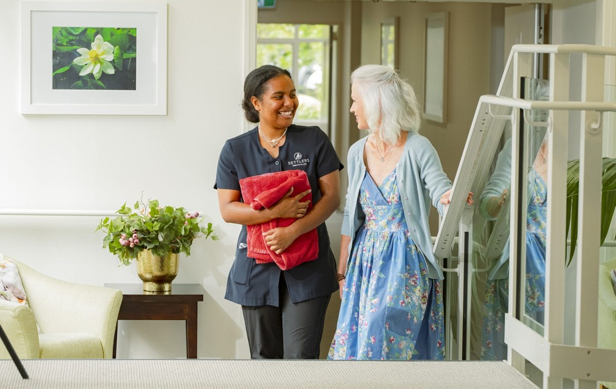high end senior living community attendant helping a resident